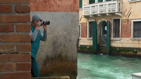 photographer working by the canal in venice