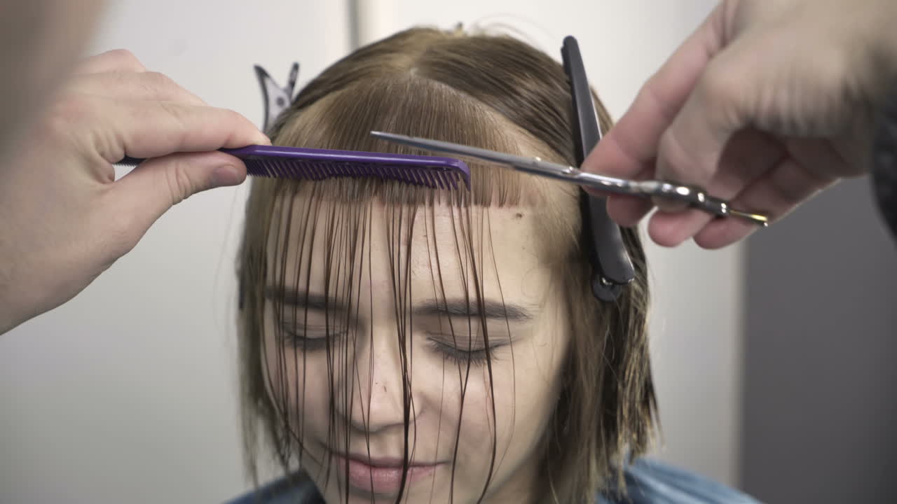 Young woman having her hair dyed by beautician at parlor