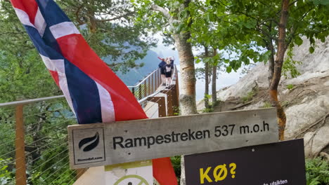 Close-Up-Of-Rampestreken-Viewpoint-Sign-With-Norwegian-Flag-In-Andalsnes,-Norway