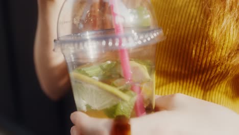 woman holding a refreshing summer drink