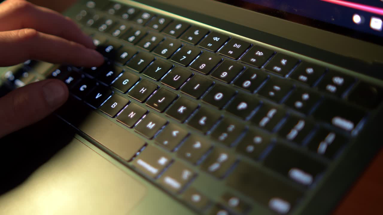 Focused hands work on a laptop, highlighting digital icons on the screen. Ideal for technology and productivity themes
