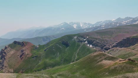 drone view snowy mountain peaks in sunny weather, serene and expansive