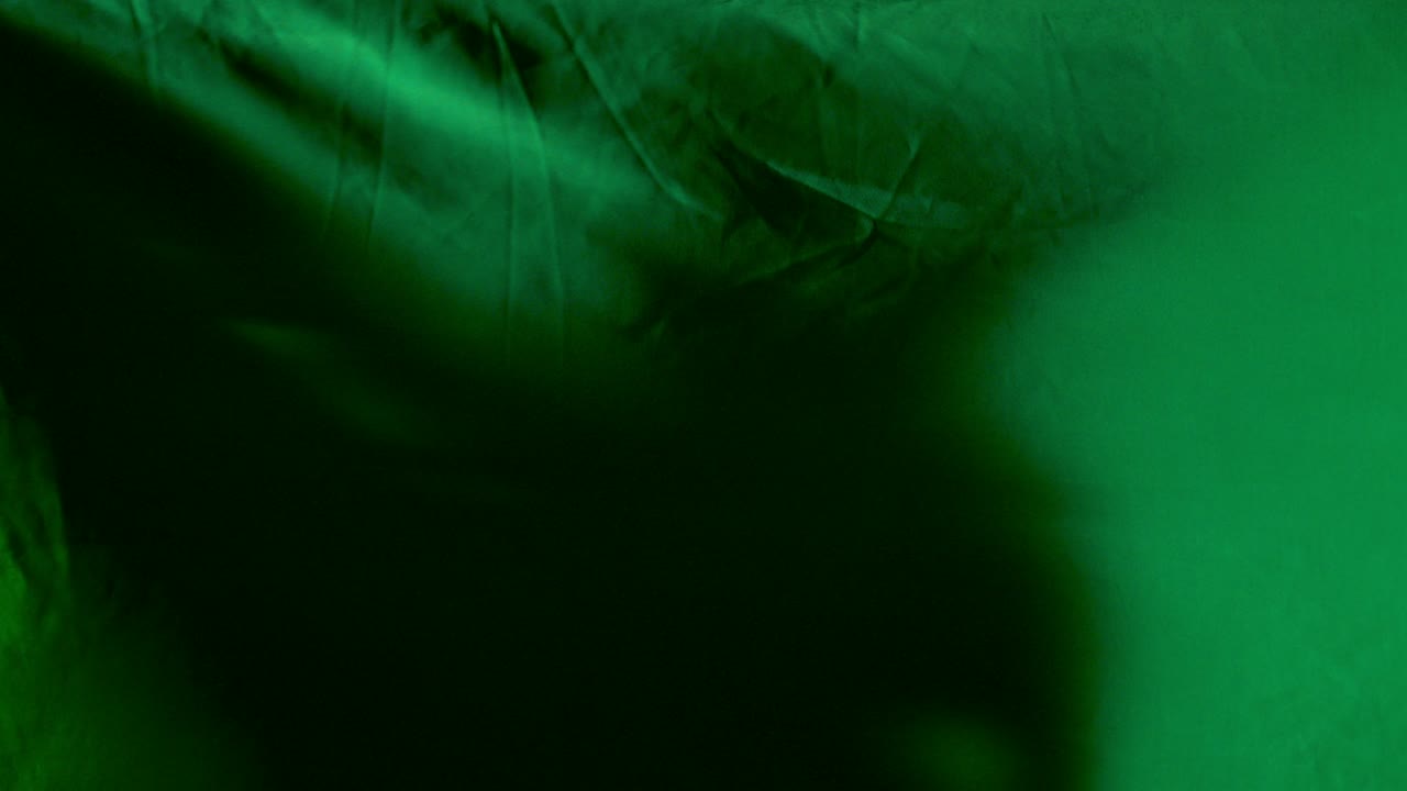 Green Seamless Wave satin fabric Background \ Silk cloth fluttering in the wind of waving cloth \