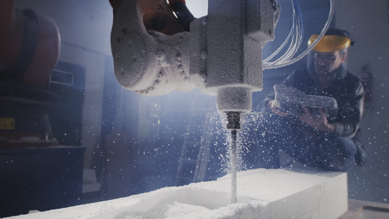 Robotic arm drilling into a block of foam