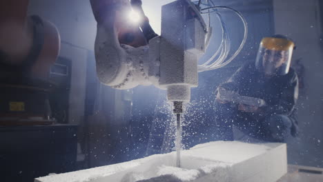 robotic arm drilling into a block of foam