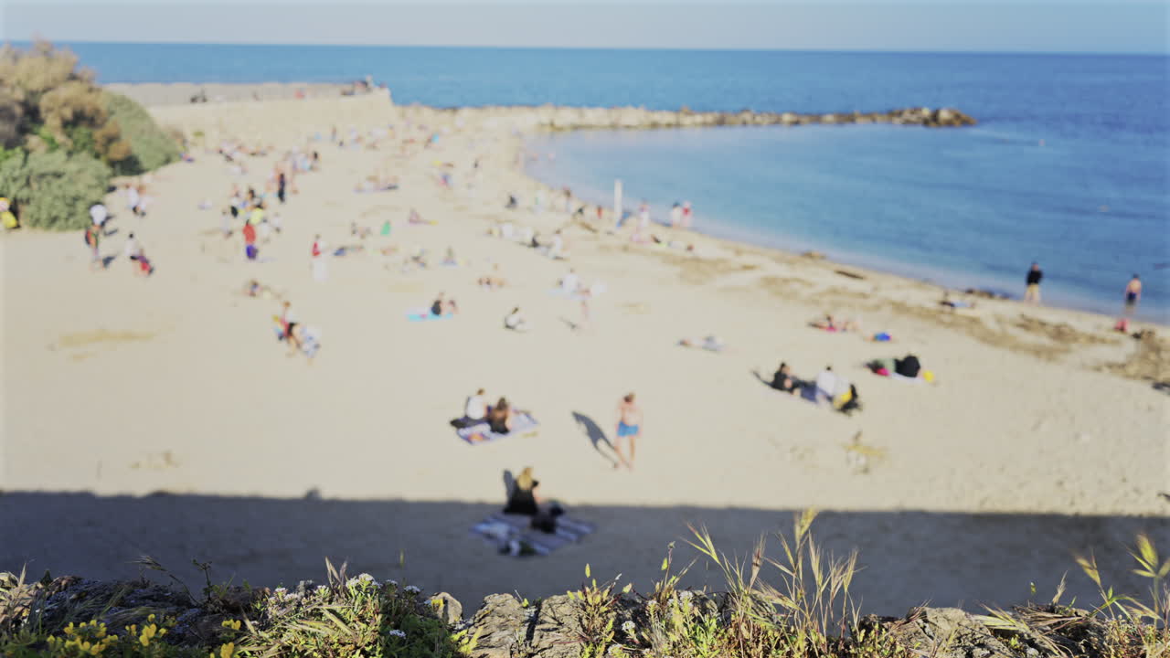 Blurred view of people on the Gravette Beach in Antibes, France