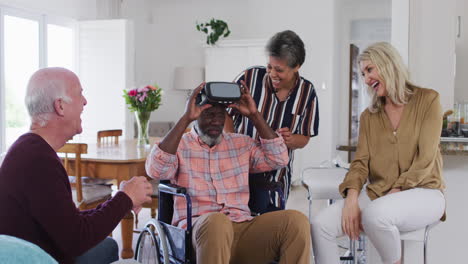 two diverse senior couples sitting on a couch disabled african american man is using vr googles