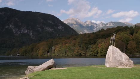 fast-moving clouds passing over lake bohinj with stunning autumn colours and triglav national park in the background