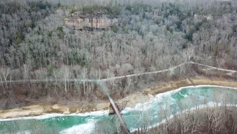 bridge and mountain cliff reveal