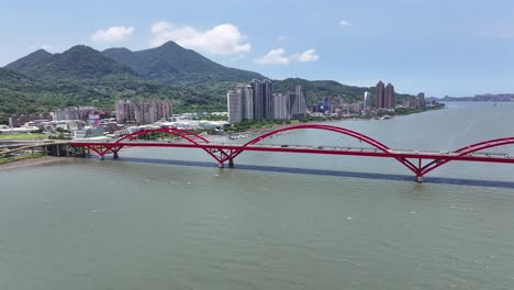 guandu bridge, iconic arched bridge and taipei cityscape