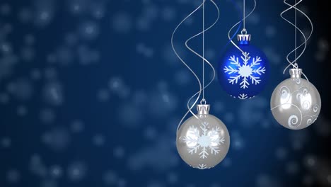 Animation-of-snow-falling-over-christmas-balls