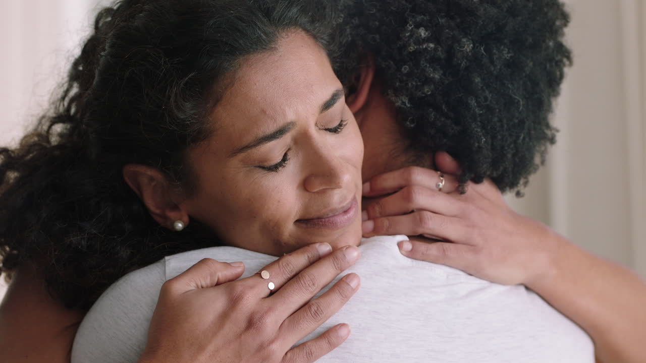 unhappy woman hugging boyfriend young couple having relationship trouble embracing emotional issues sharing bad news