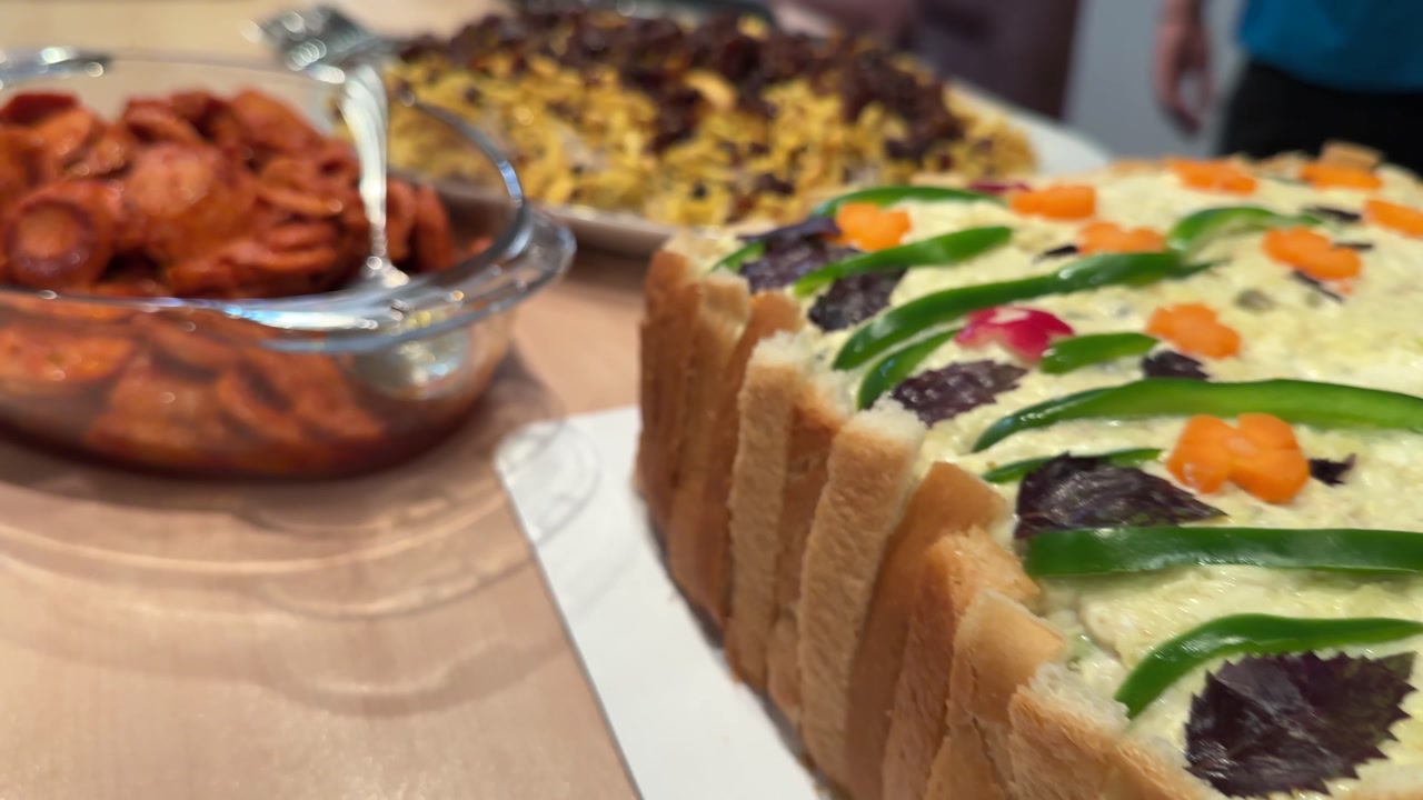 Persian party buffet with sosis bandari adas polo sandwich cake and creamy kashke bademjan side dish Handmade dishes featuring roasted eggplant garlic tangy yogurt and traditional flavors in Tehran