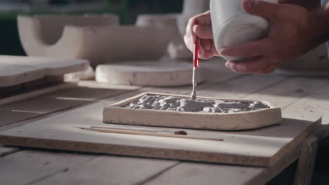 artisan sculpting with clay and mold