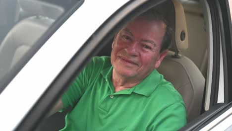 man-in-white-car-waving-after-a-new-car-purchase