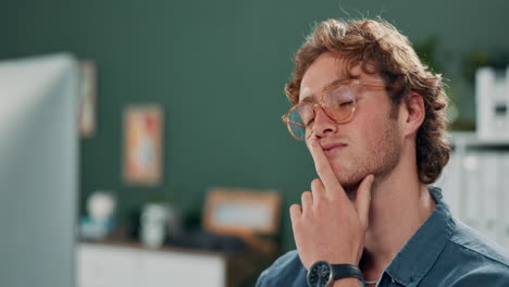 man thinking in front of a computer