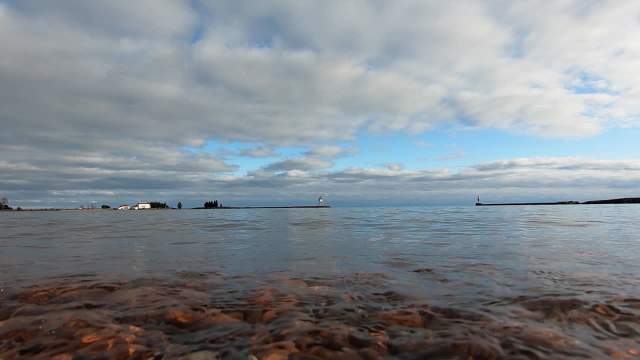 미네소타 주 그랜드 마레에 있는 우수한 호숫가에 물이 찰싹 달라붙고 있습니다.