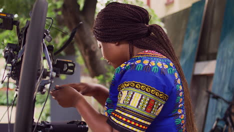 young woman repairing bicycle rim