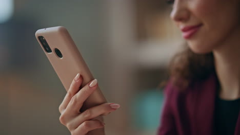 closeup worker touching smartphone in office. hands holding cellphone device