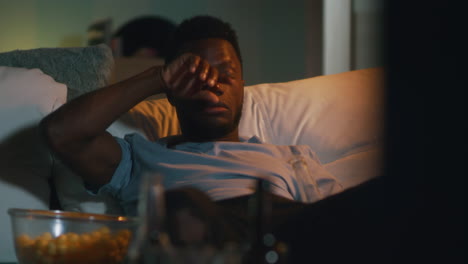 man relaxing and watching tv at night