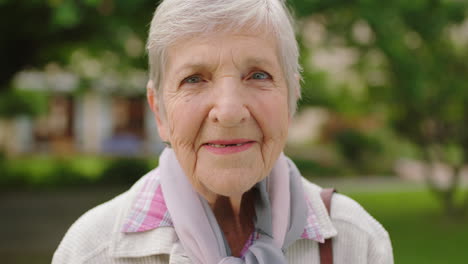 senior woman portrait in a park for retirement