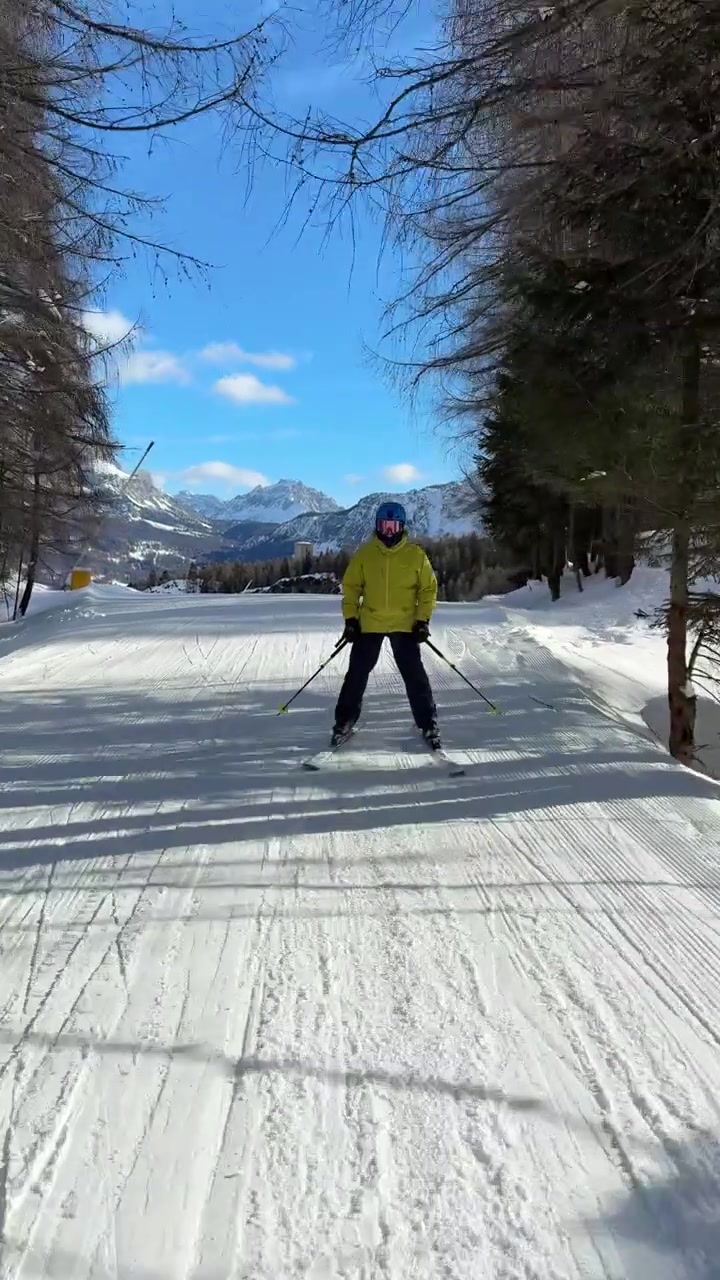 Skier Descends Snowy Winter Slopes In Cortina d'Ampezzo In The Dolomites Of Italy. POV Tracking Shot