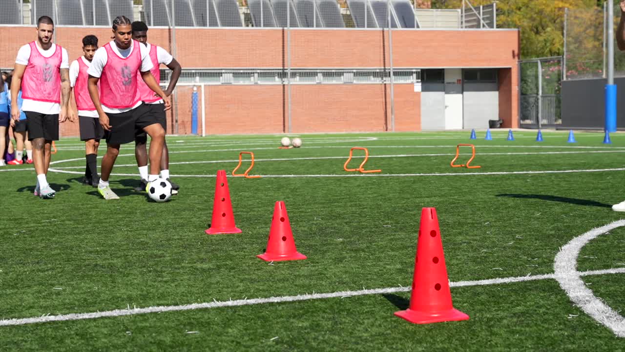 Soccer training session with cones and soccer balls on a grass field