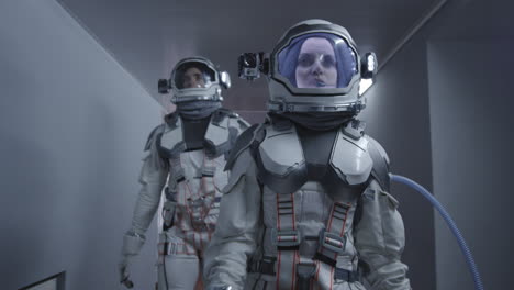 Astronauts Walking in a Spacecraft Corridor