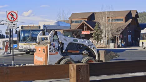 Front-end-loader-coming-to-stop-in-front-of-a-bus-stop