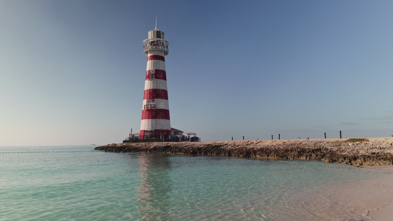 Striped Lighthouse on a Tropical Beach