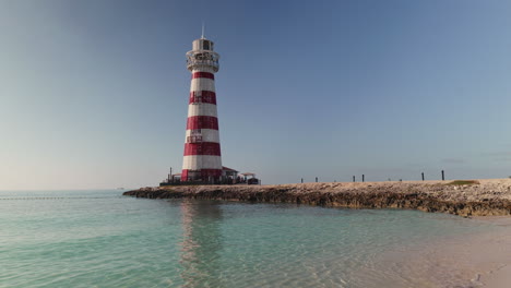 striped lighthouse on a tropical beach