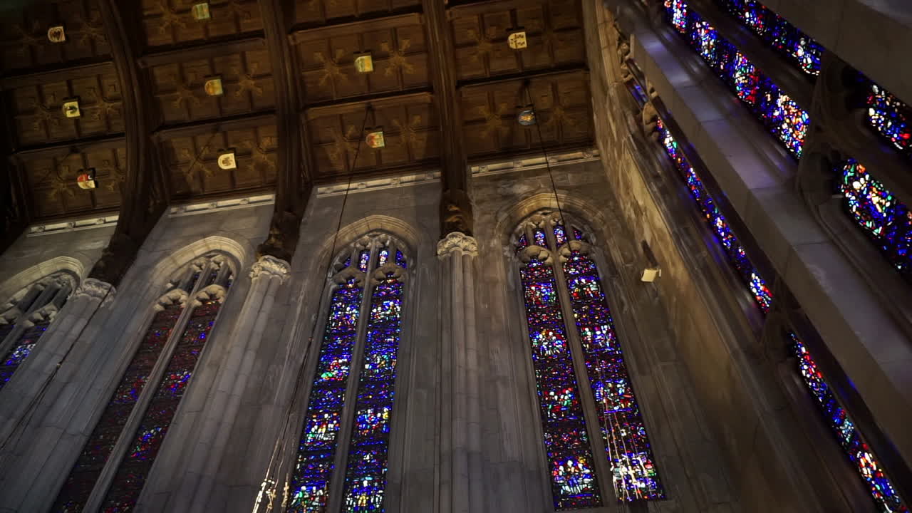 Cathedral ceiling with stained glass windows and wooden ceiling panels