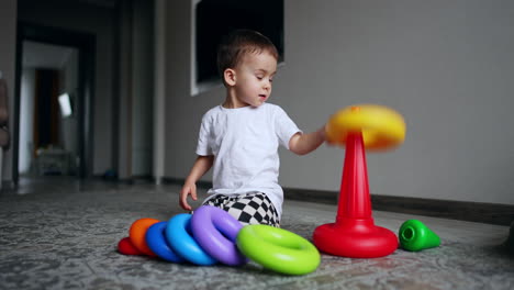 preschool fun game learning. little cute boy playing with colorful toy.