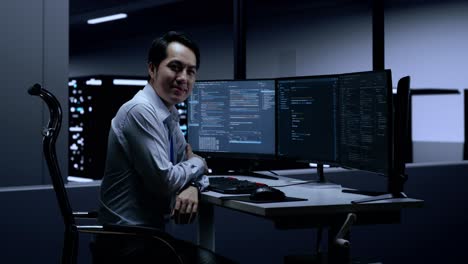 Smiling Programmer in a Server Room