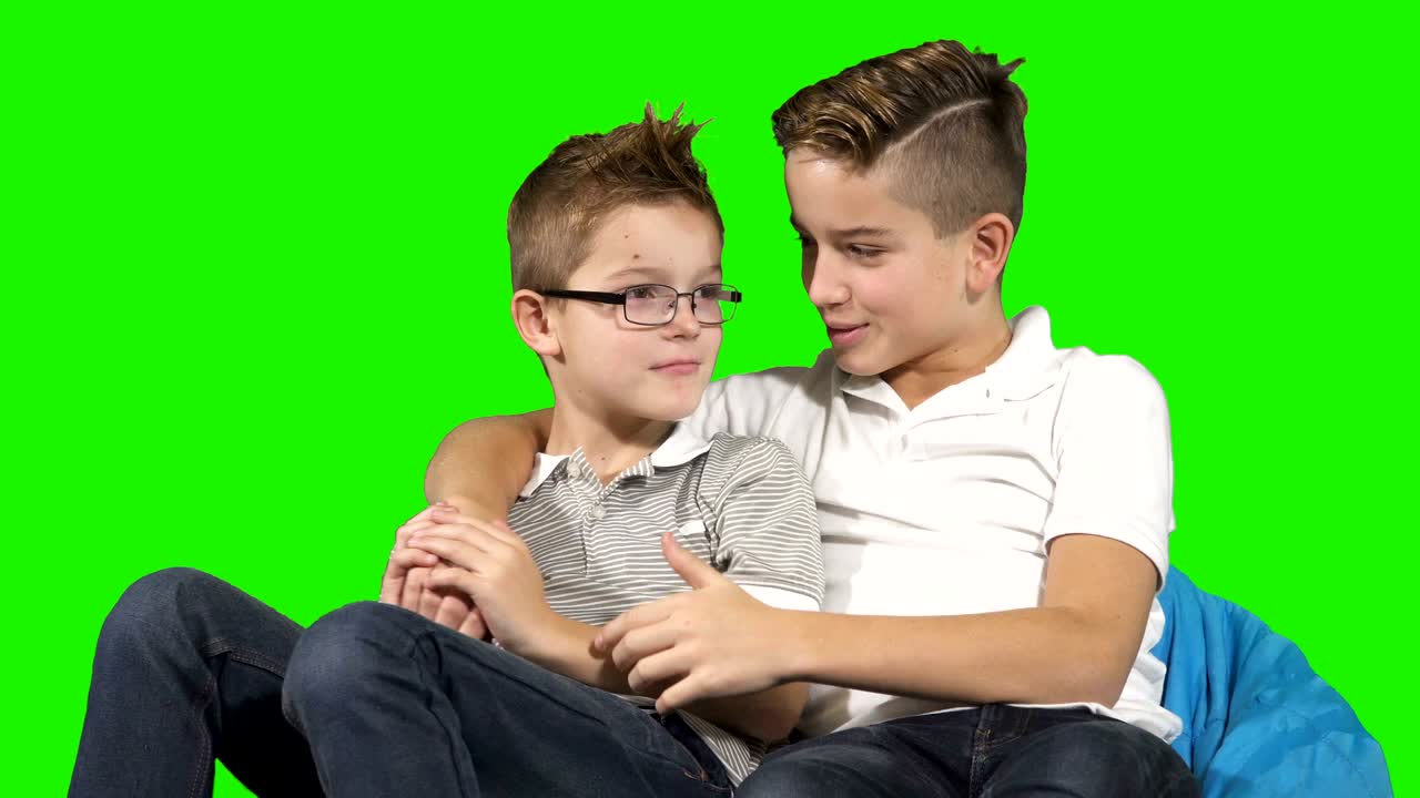 Little brothers are fooling around at chroma key background
