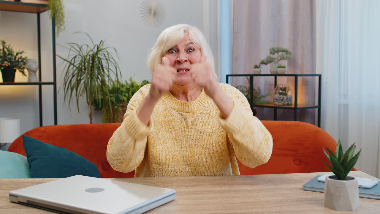 Excited senior woman surprised shocked by sudden victory good win news celebrating wow reaction