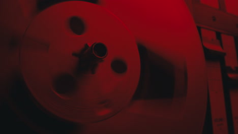a close-up on a vintage tape recorder in a red blinking light