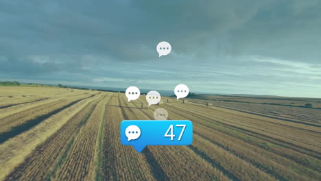 blue comment bubble showing 47 floating above golden field rows with hay bales and white icons