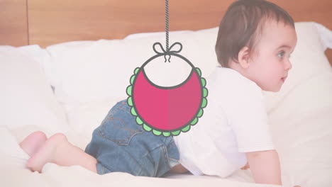 animation of hanging bib over caucasian baby on bed