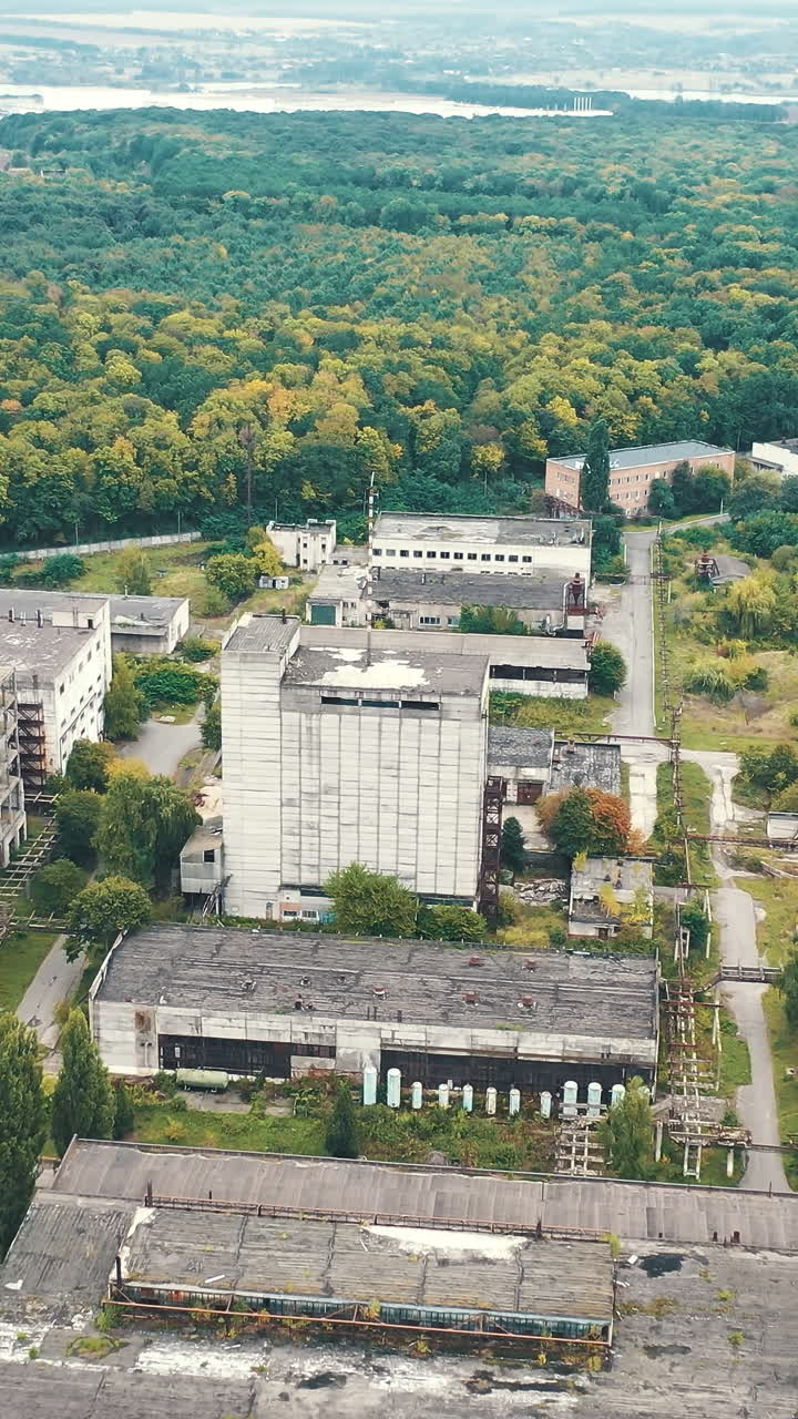 Big factory buildings drone view. Cement industrial factory building equipment. Vertical video