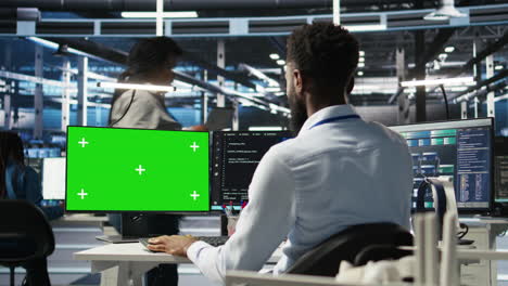 data center admin using green screen pc to do node tree programming