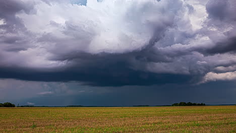 dark storm clouds above rural landscape, time lapse view