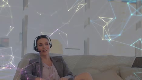 Animation-of-network-of-connections-over-businesswoman-with-headset-in-office