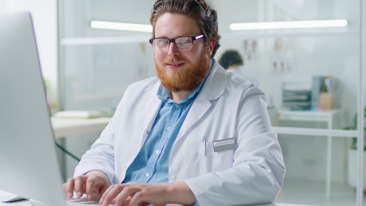 Portrait of Cheerful Doctor at Work in Clinic