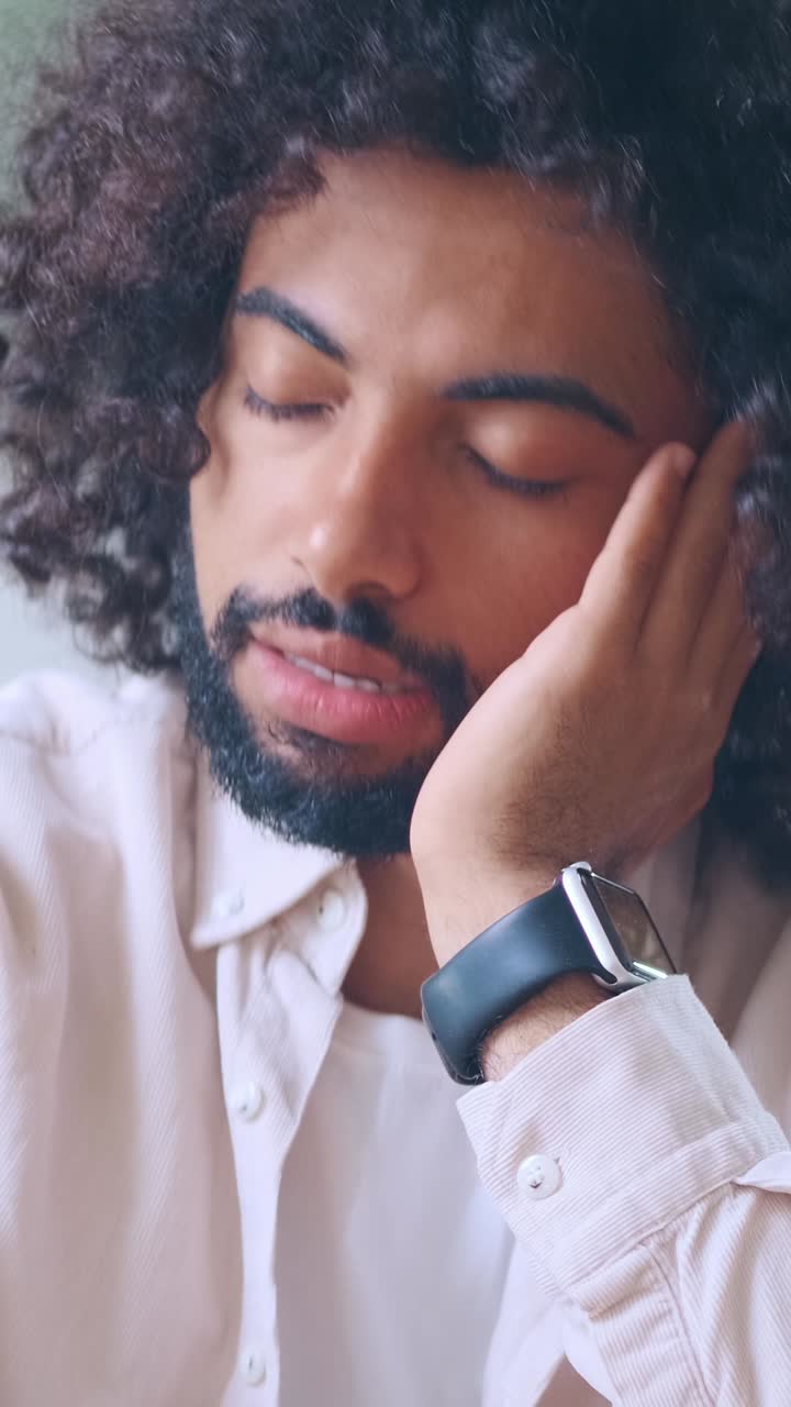 Relaxation moment captured in a cozy indoor setting with a thoughtful individual