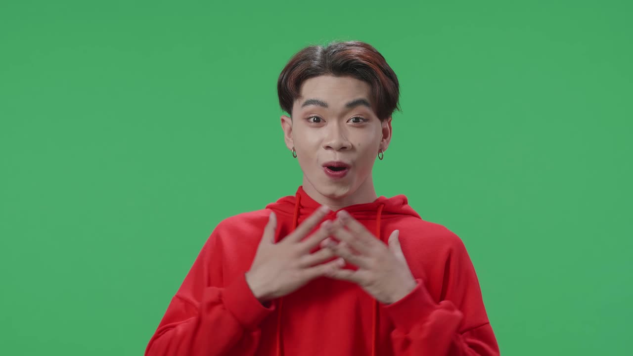 The Shocked Asian Transgender Male Grabbing His Head While Saying Wow On Green Screen Background In The Studio