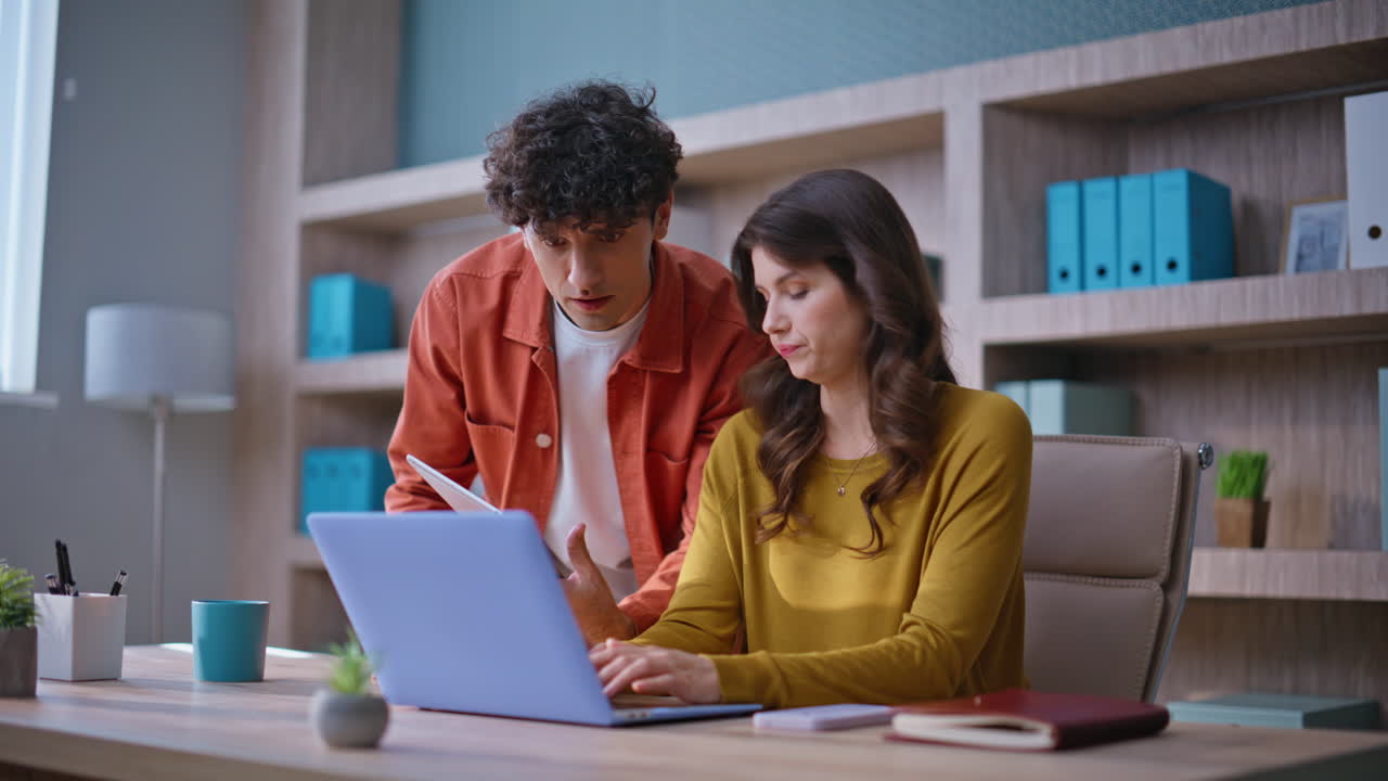 Professional coworkers discussing project in modern office. Focused colleagues