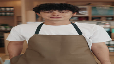man in apron at cafe