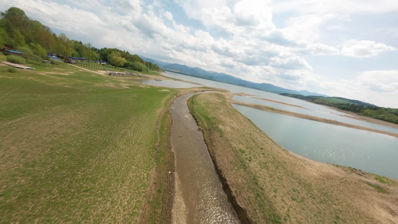 Lone reservoir in the countryside, signs of drought from above