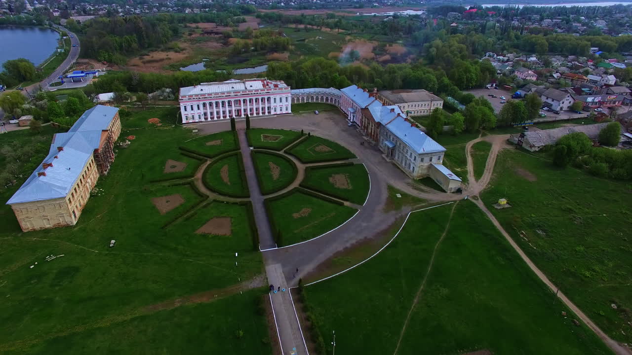 Flight over historical palaces in Tulchin, Vinnytsia region, Ukraine. Top vie wof the old residence and surrounding inhabited landscape.